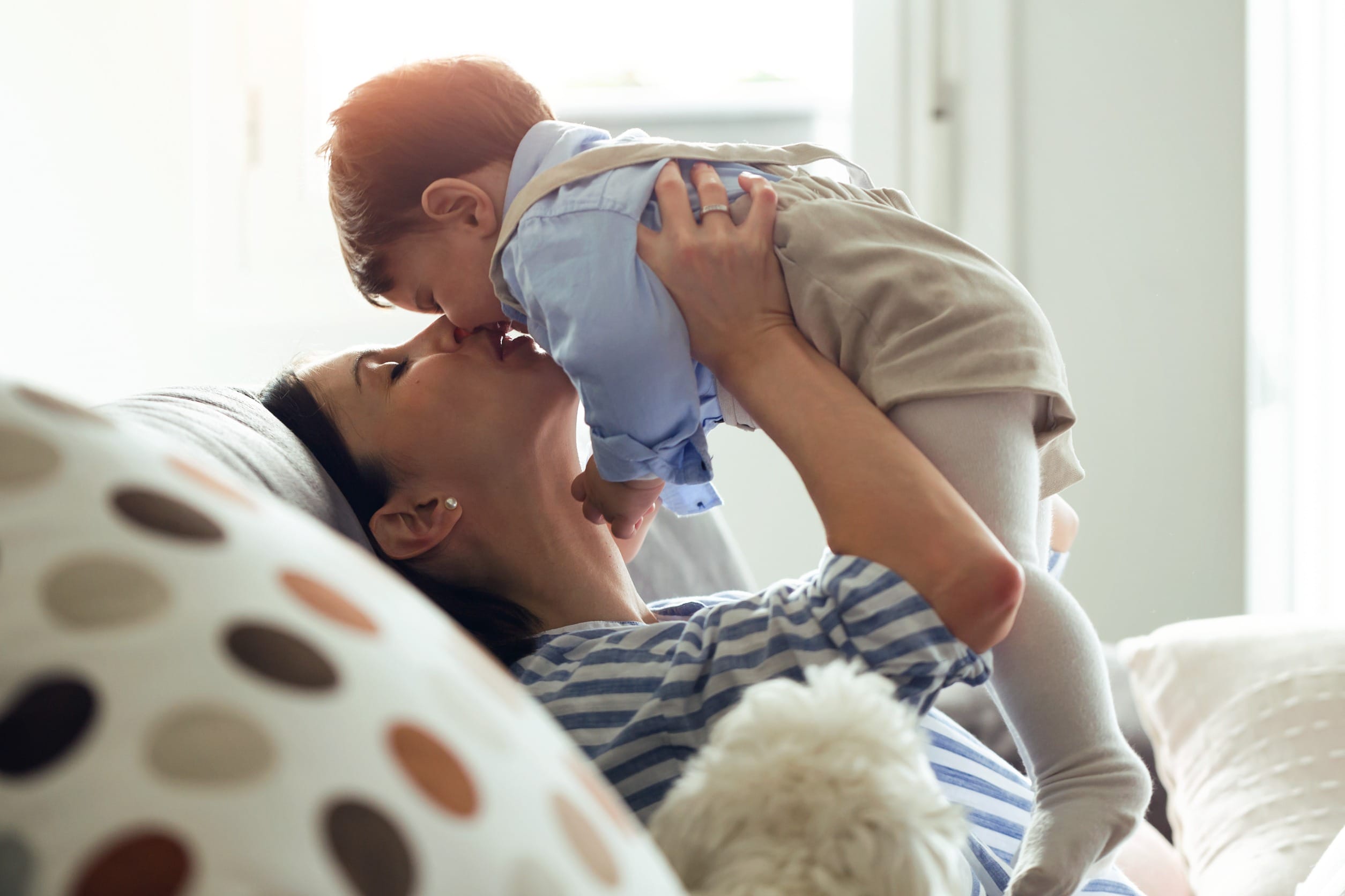 mom kissing baby