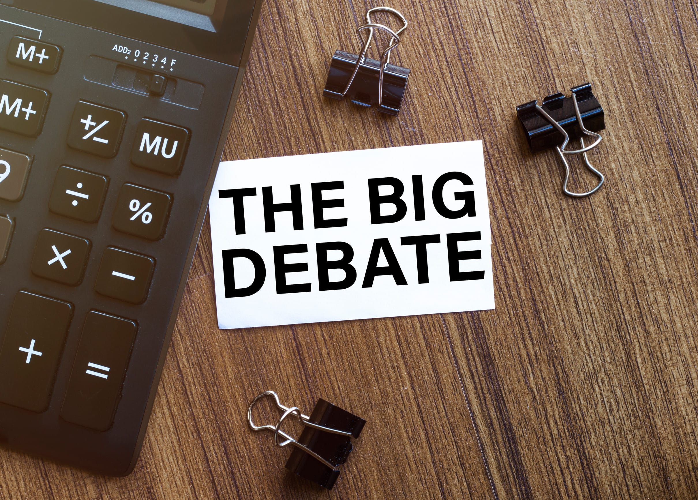 white paper with text The Big Debate on a black background with stationery