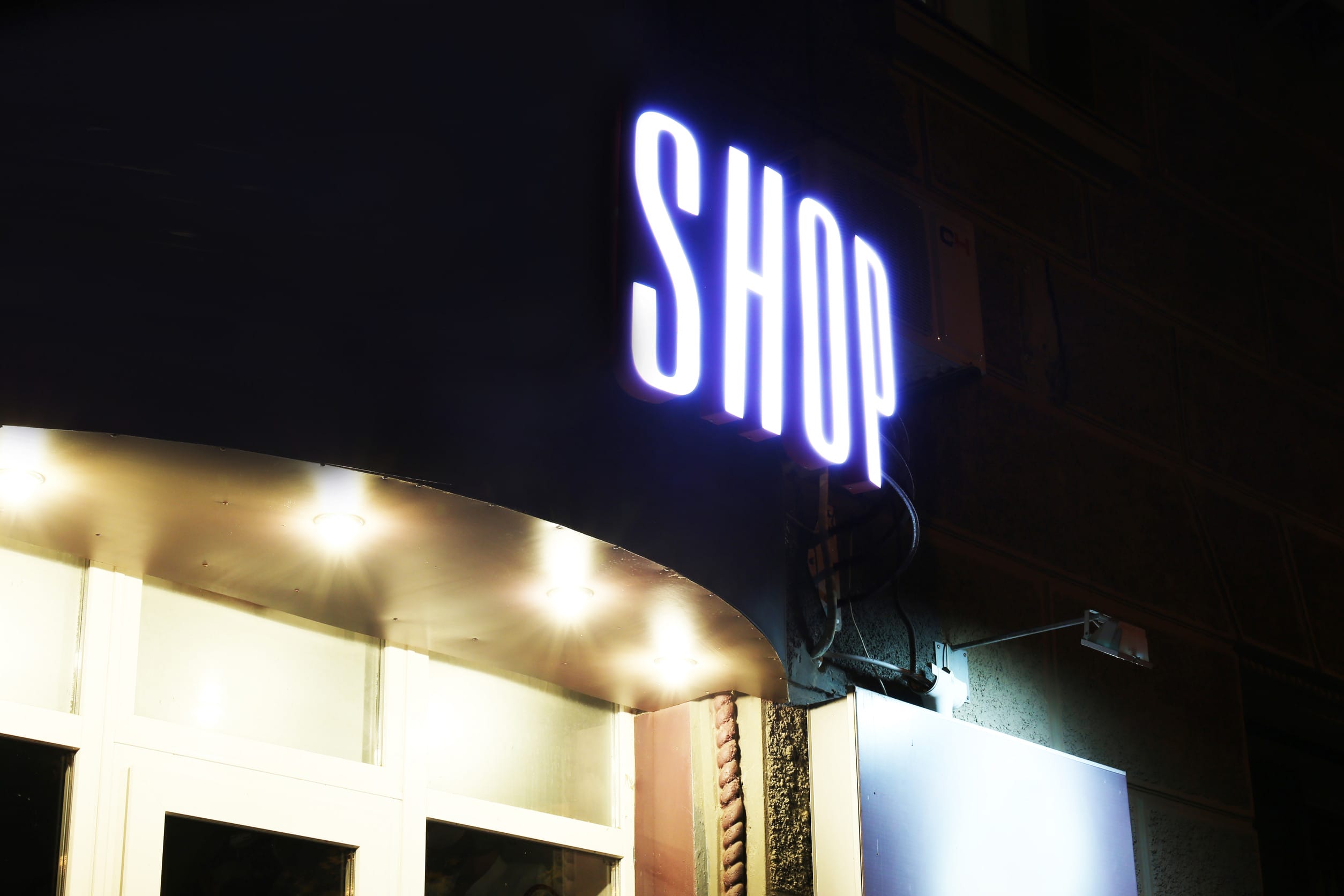 Neon sign on store at night