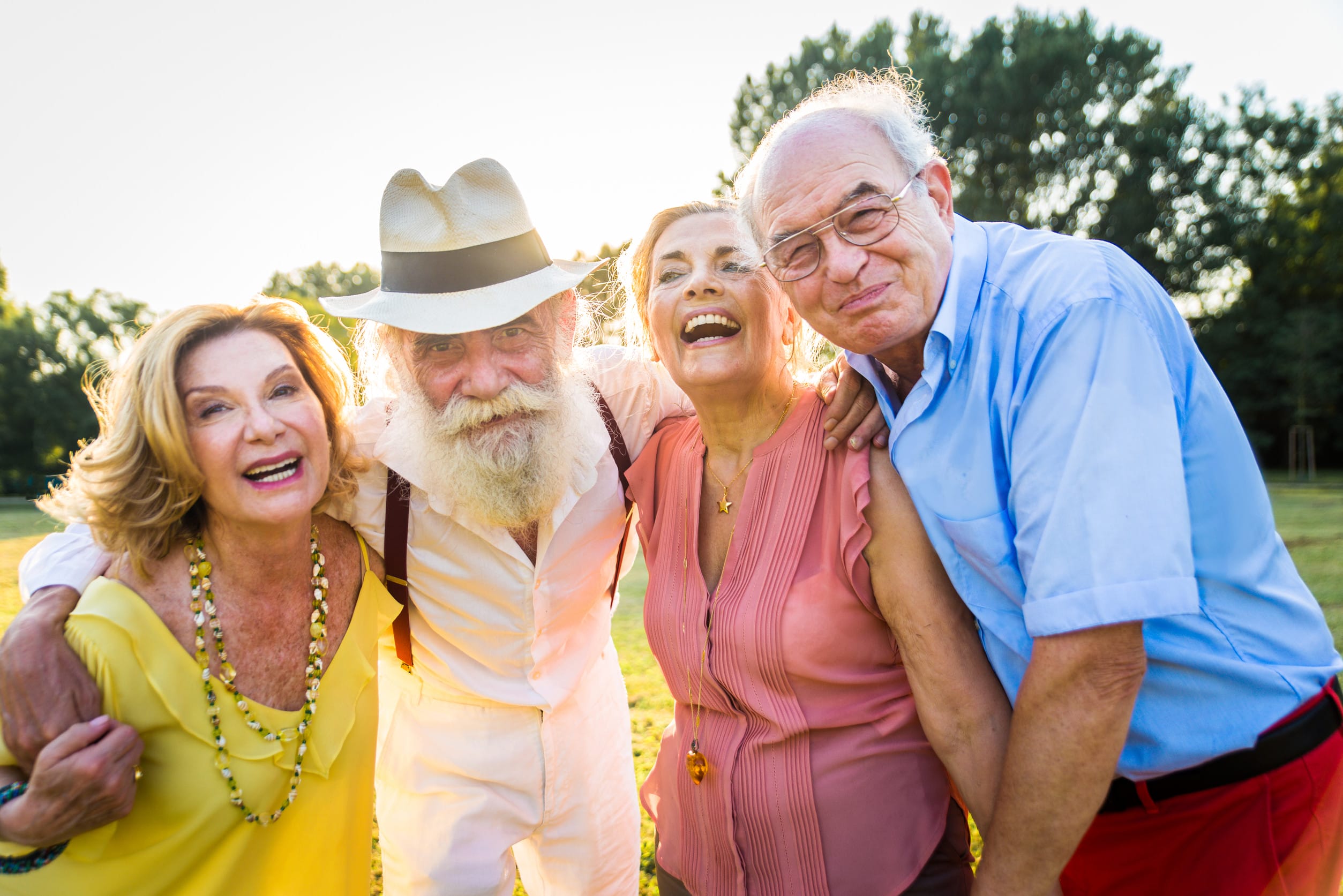 Group of youthful seniors having fun outdoors - Four pensioners bonding outdoors, concepts about lifestyle and elderly
