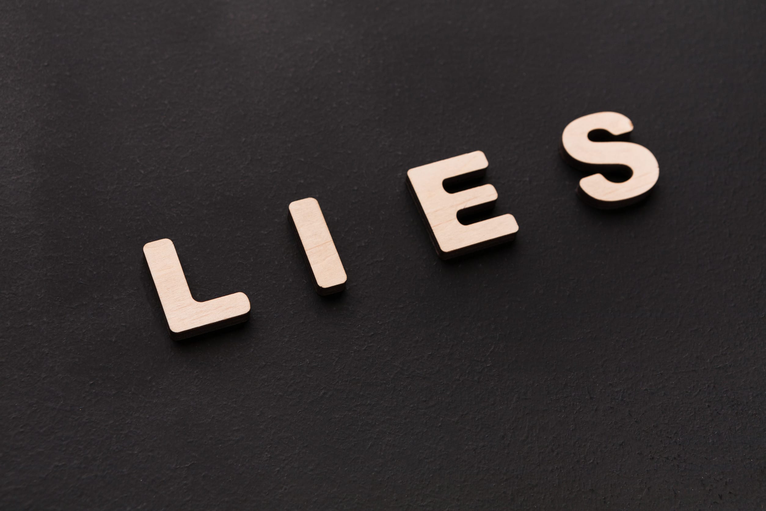 Word Lies on black background. Untruth, taradiddle, fake concept