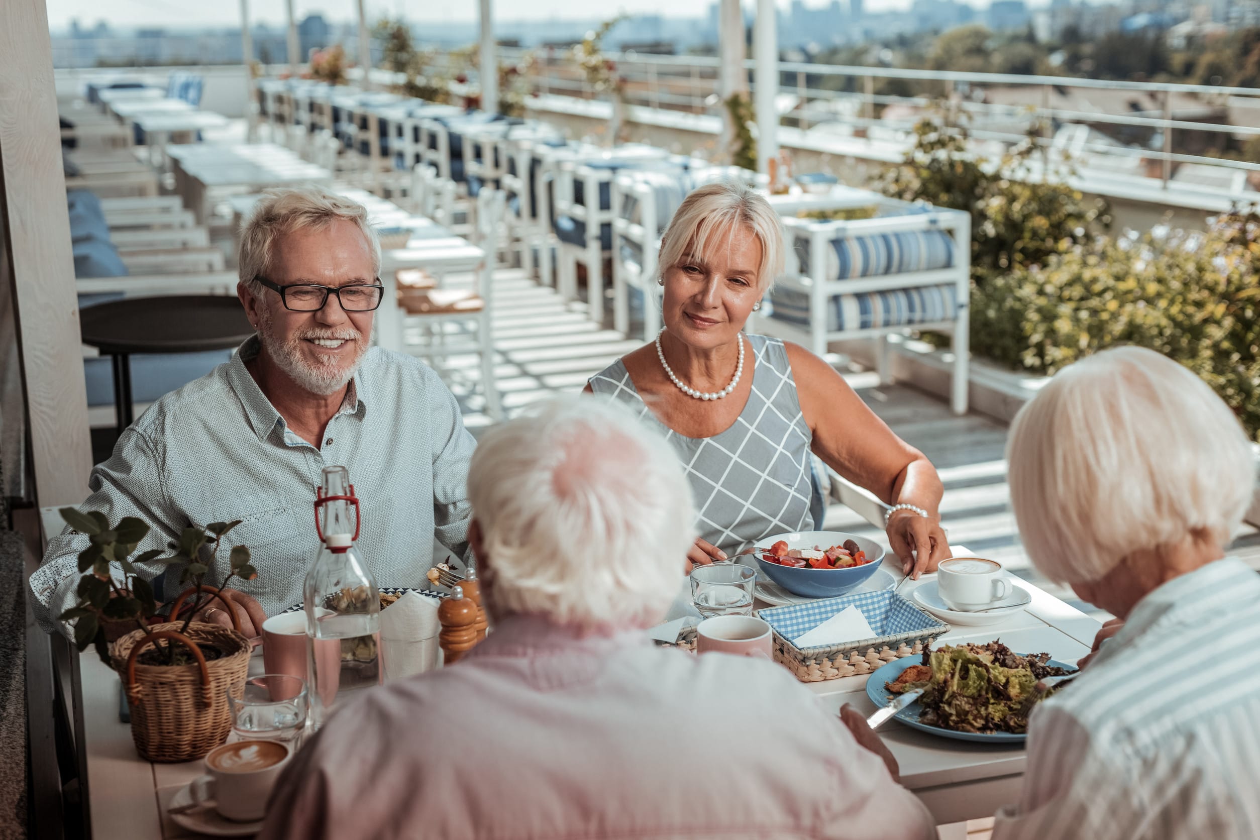 Be positive. Attractive female person eating healthy salad while being in all ears