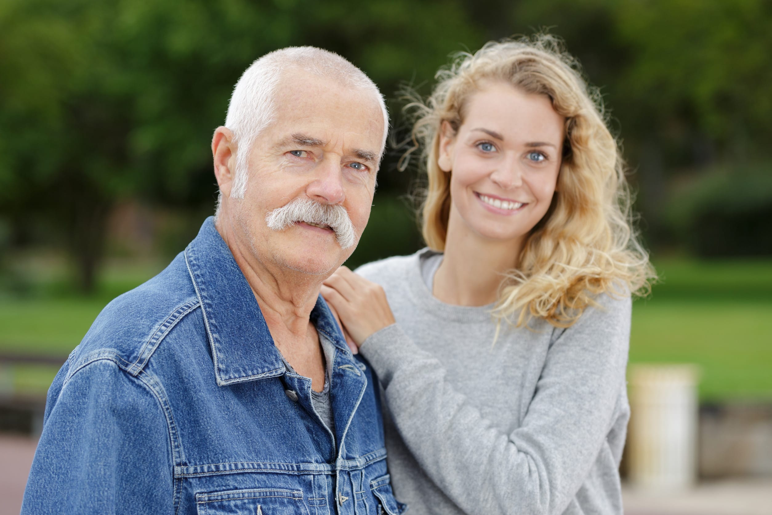 portrait of elderly man and young woman in the park
