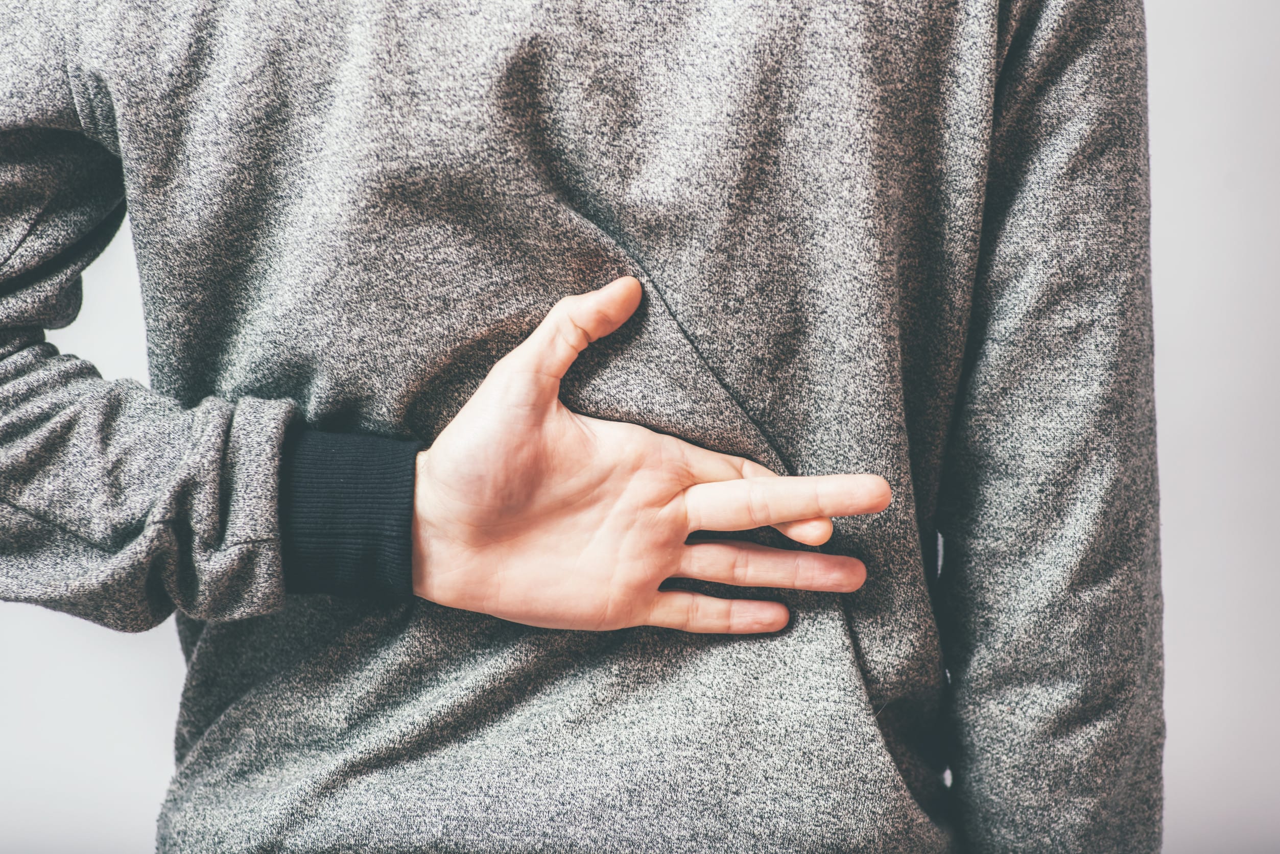 man crossed his fingers