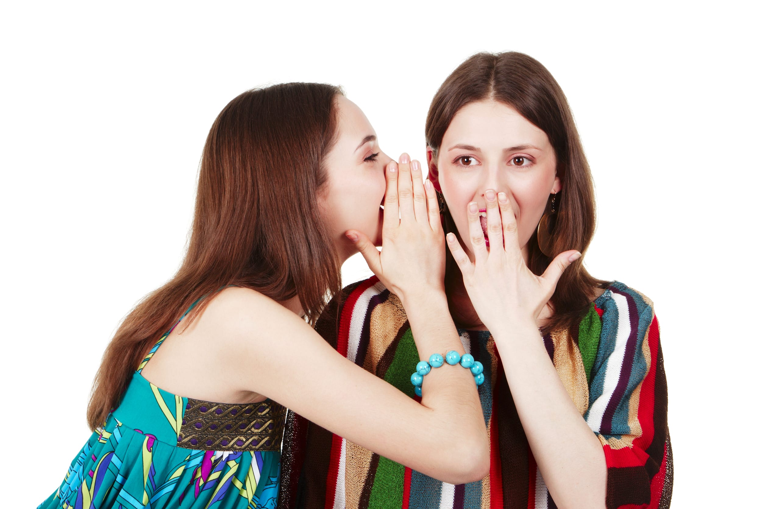 two happy young girlfriends talking over white