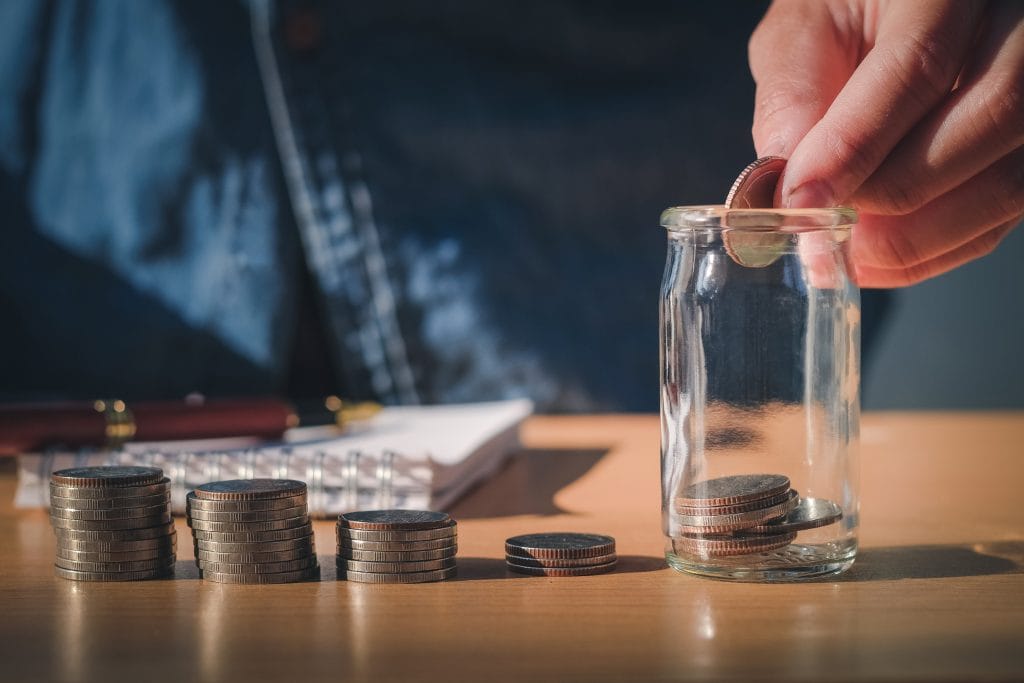 Saving money concept Man hand putting Row and coin stack growing